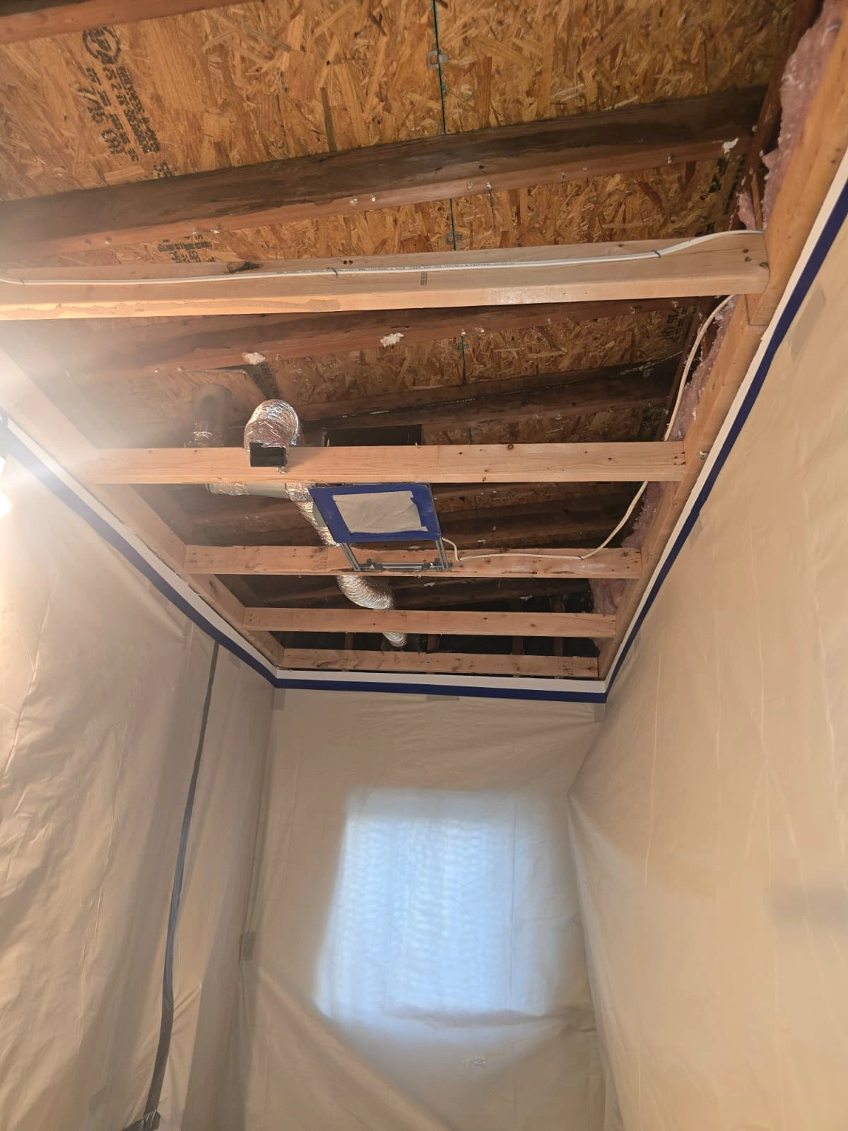 Sealed plastic containment with HEPA filtration during asbestos abatement