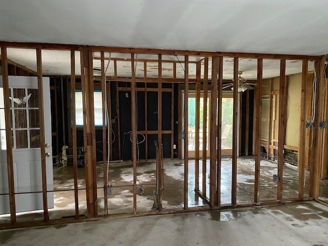 Wide view of interior studs after completed asbestos drywall removal